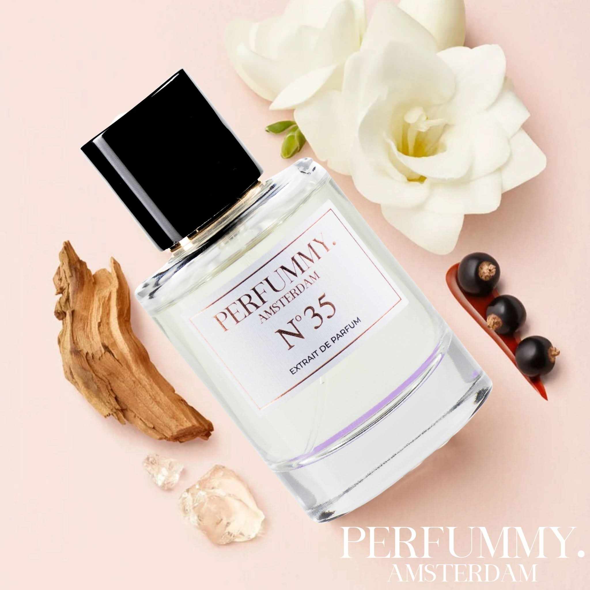 Perfume bottle of Nº 35 Inspired by Si featuring floral and fruity notes with blackcurrant, rose, freesia, vanilla, and patchouli on a soft pink background with flowers and wood accents